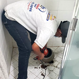 Plumber Conducting Drain Cleaning